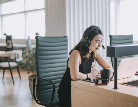 an asian chinese mid adult white collar worker talking to the camera video calling video conference with his business partners  with face mask